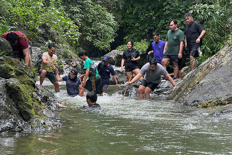 A team doing a river trek as part of their teambuilding.
